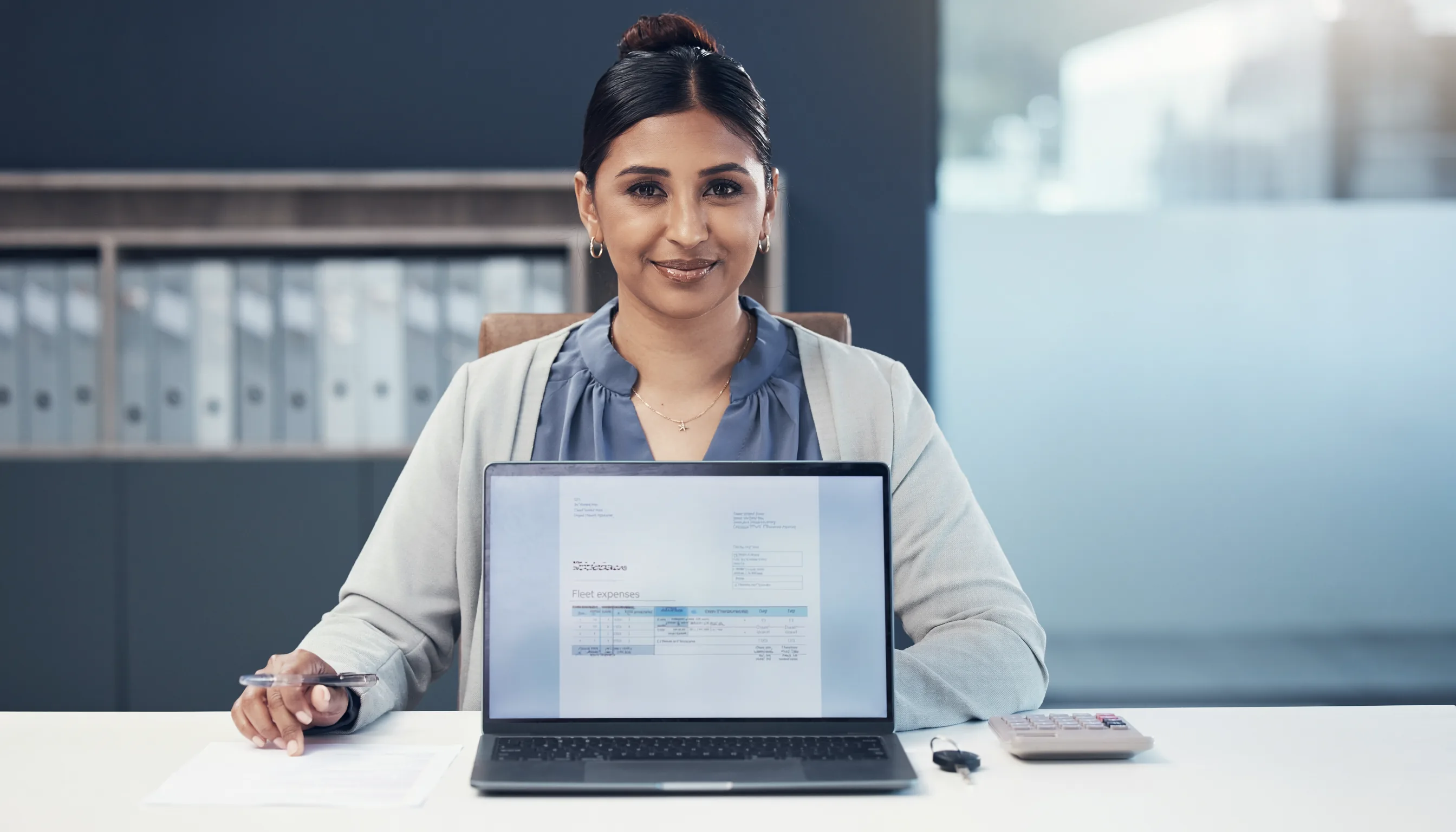 Finance specialist reconciling fleet invoices and costs in accounting software