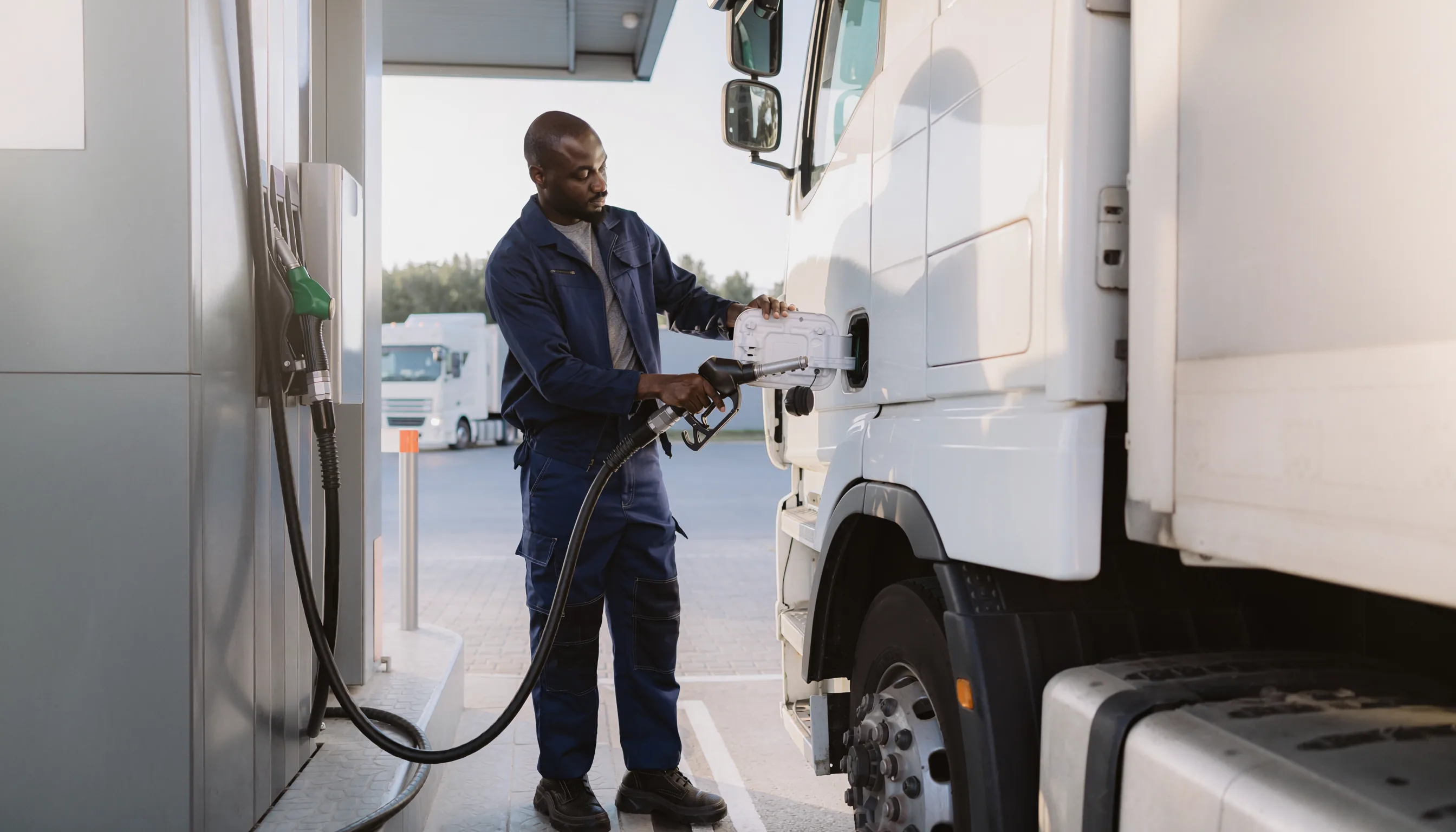 Fleet driver refuelling a commercial truck at a diesel pump